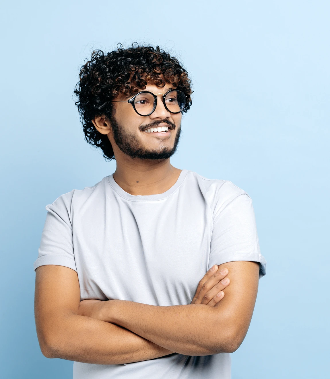Young man in glasses smiling and looking to the right